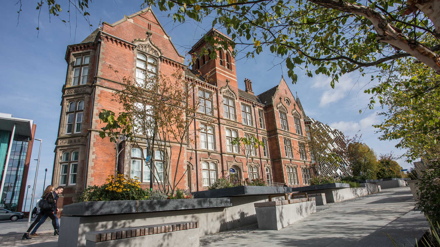 Historic University of Sheffield campus building beside a landscaped walkway